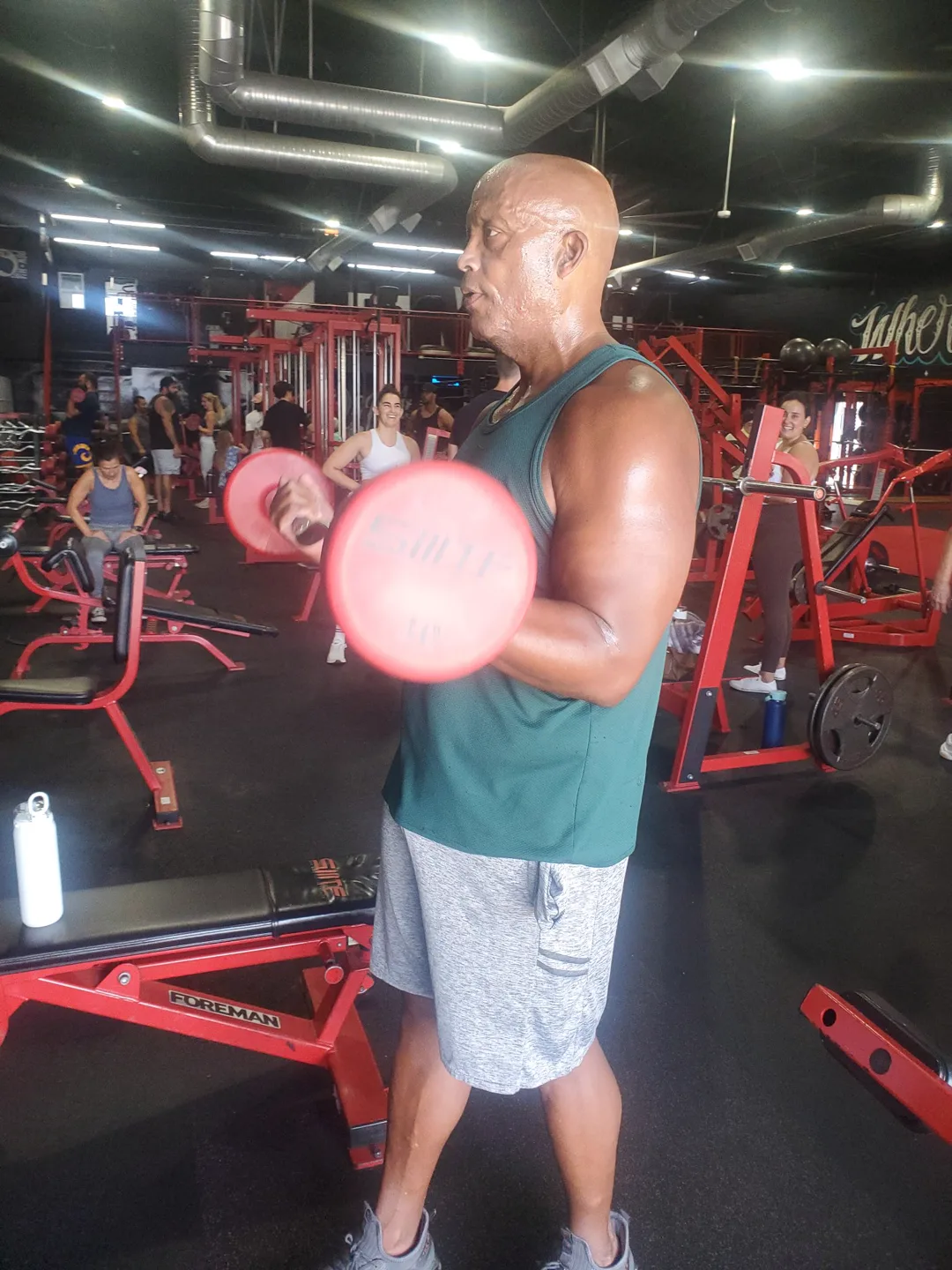 Coach Bizz curling dumbbells — leading by example